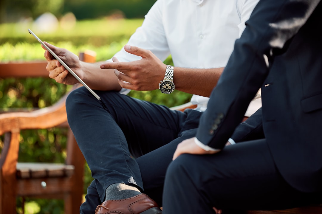 about-01 two businessmen having a meeting in the park